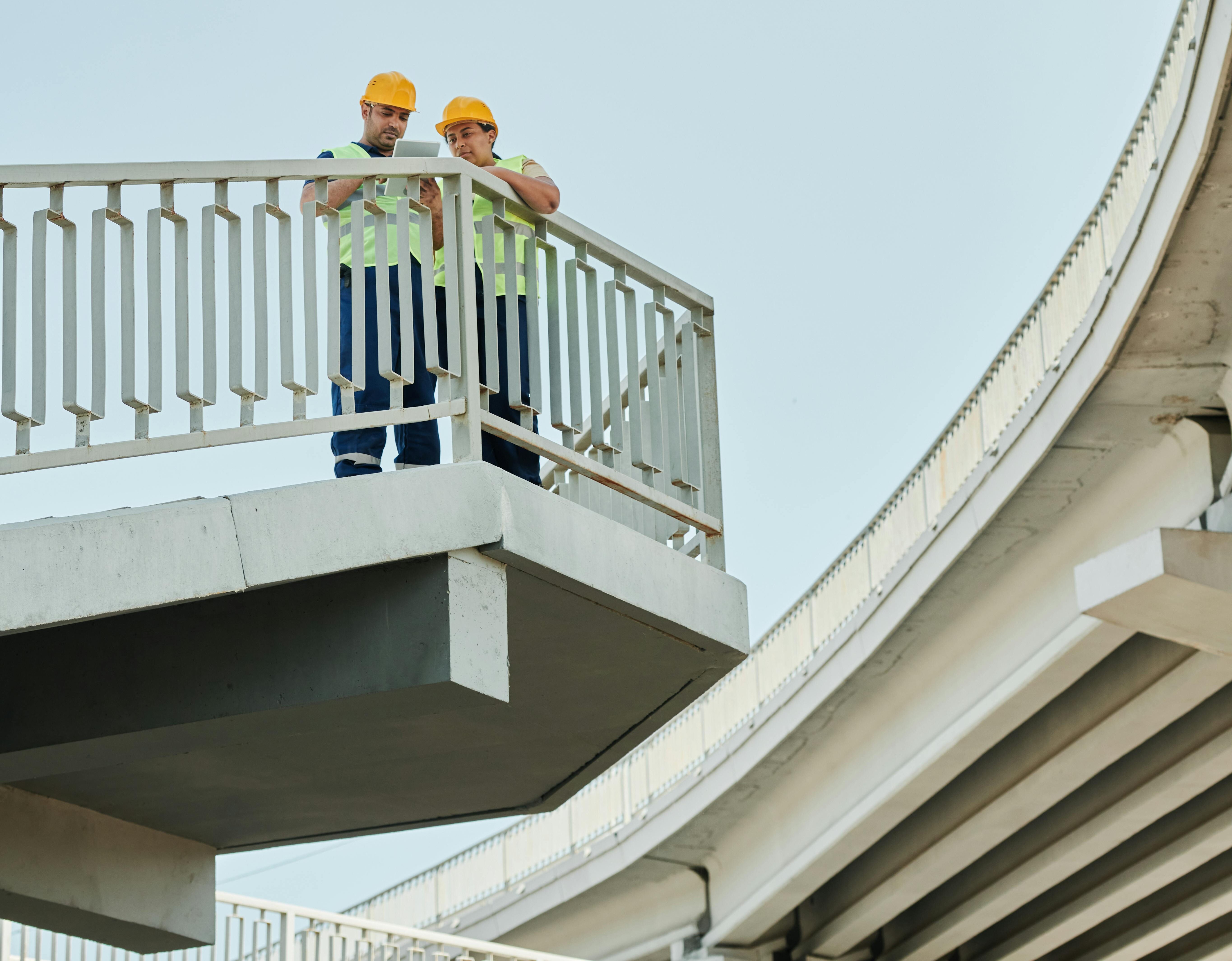2 man standing on top of stairway working